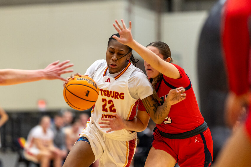 Pittsburg State freshman guard Ja'Miya Brown attempts to drive past a Rogers State defender during their game Wednesday night at John Lance Arena.