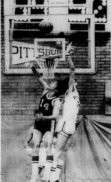 LAST-DITCH EFFORT. John Loop (14) of Columbus battles Pittsburg&rsquo;s Dave Eichhorn for a rebound in the waining moments of Pittsburg&rsquo;s 59-52 SEK win over the Titans.&nbsp;