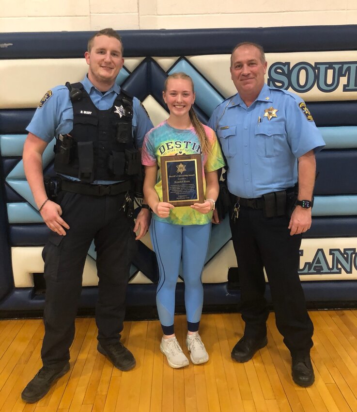 Kendyl Renn, center, was presented the Sheriff&rsquo;s Citizenship Award for her actions on the morning of January 25. The award was the brainchild of Deputy Devin Ulery, left, who witnessed firsthand Renn&rsquo;s actions that day, and Sheriff Danny Smith, right, who agreed that her heroism should be recognized.