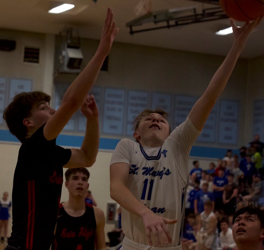 St. Mary's Colgan freshman Brady Bettega lays in a basket early in the second quarter Saturday night against Erie.