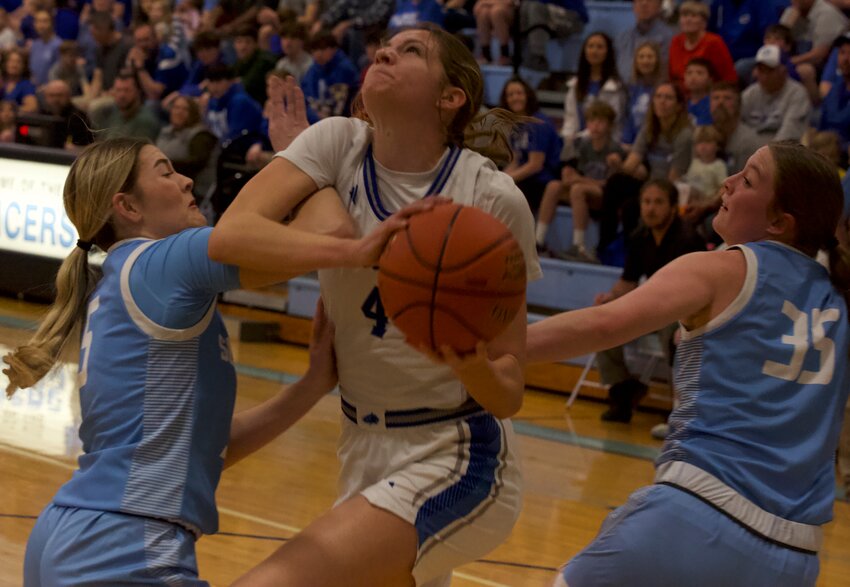 St. Mary's Colgan senior Lily Brown draws a foul against either Southeast' s Kinzey Cassidy (5) or Teagan Warner (35) during their sub-state championship game Saturday at Southeast High School