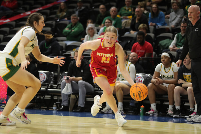 Pittsburg State's Grace Pyle drives past Missouri Southern's Kennady Roach during Friday afternoon's game in the MIAA Postseason Tournament in Kansas City, Mo.