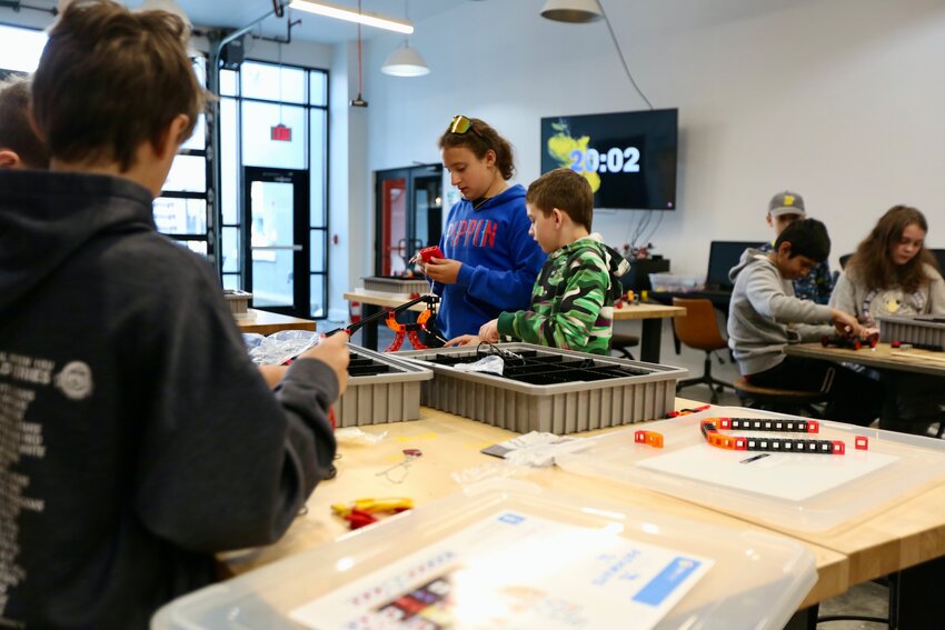 Children in attendance at Wednesday&rsquo;s &lsquo;STEMtastic Adventures&rsquo; event held at Block22 work away at their STEM car model kit, participating in a number of hands-on activities within the Pitsco Idea Shop.
