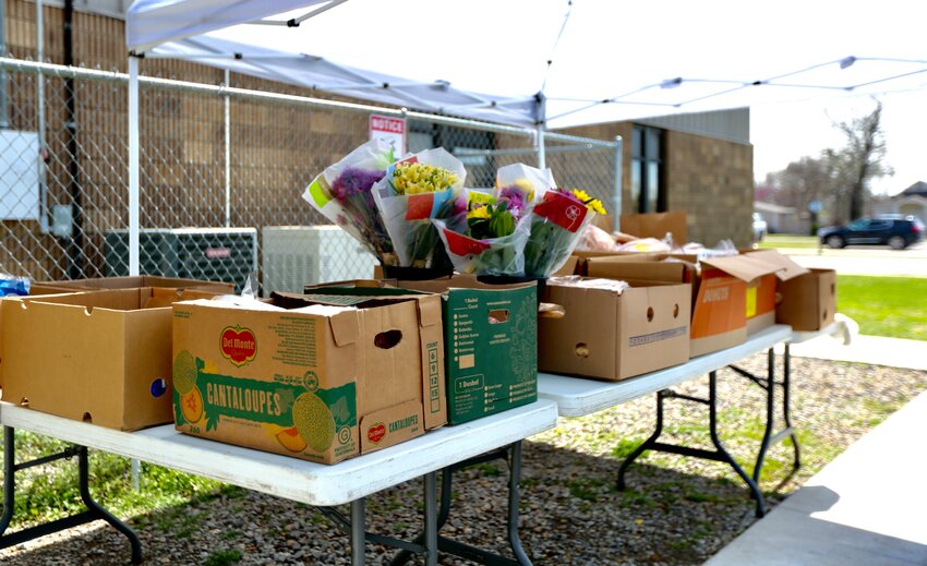 Tables full of food and flowers were set up outside Wesley House Friday afternoon as the local outreach mission announced that it is converting its food pantry to a client choice pantry.