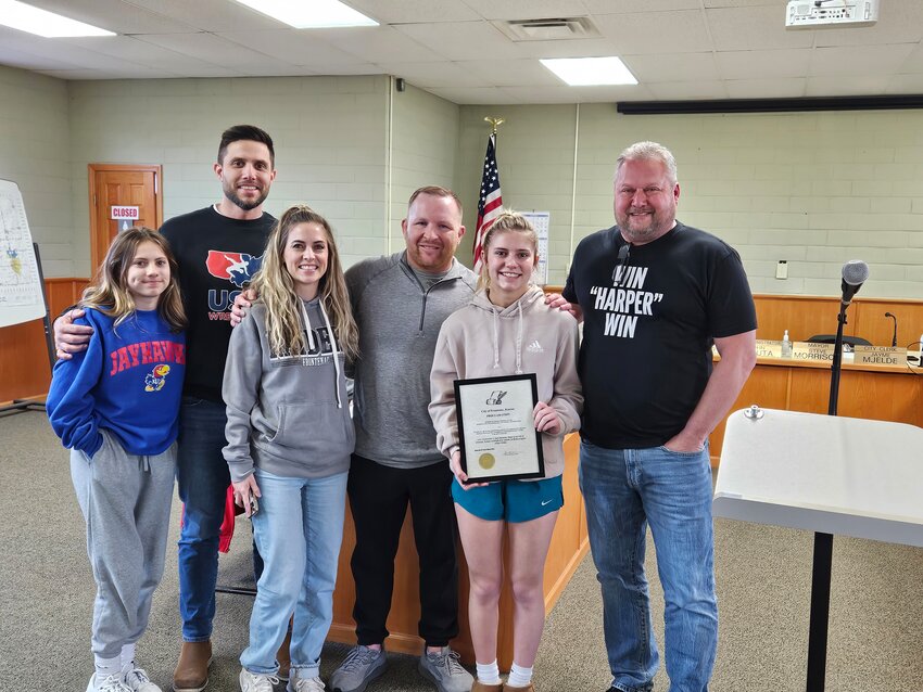 Harper Holmes, a freshman wrestler at Frontenac High School, poses with her family and Frontenac Mayor Steve Morrison after winning the state title in her weight class. Holmes is Frontenac&rsquo;s first girls wrestling state champion.&nbsp;