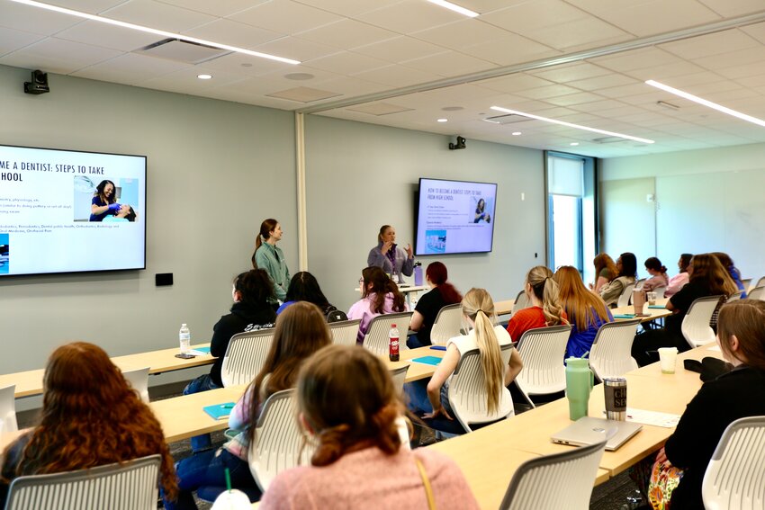 Dr. Caileen Sylvester and Dr. Katherine Bolding discuss pediatric dentistry with high school girls during Wednesday&rsquo;s career event that aimed to inform about health care careers.