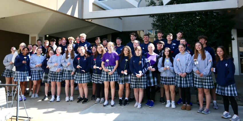 Prior to handing out their flowers and cards, high school students at St. Mary&rsquo;s Colgan gathered for a group picture outside Meadowbrook Mall in south Pittsburg.