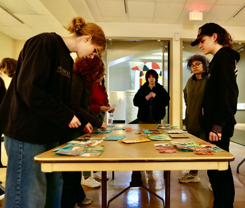 Students set out their designed trading cards along the multiple tables placed inside the Harry Krug Gallery at Porter Hall on the campus of Pittsburg State University during Thursday&rsquo;s fourth annual Artist Trading Card Event that featured students from Girard and Pittsburg High School.