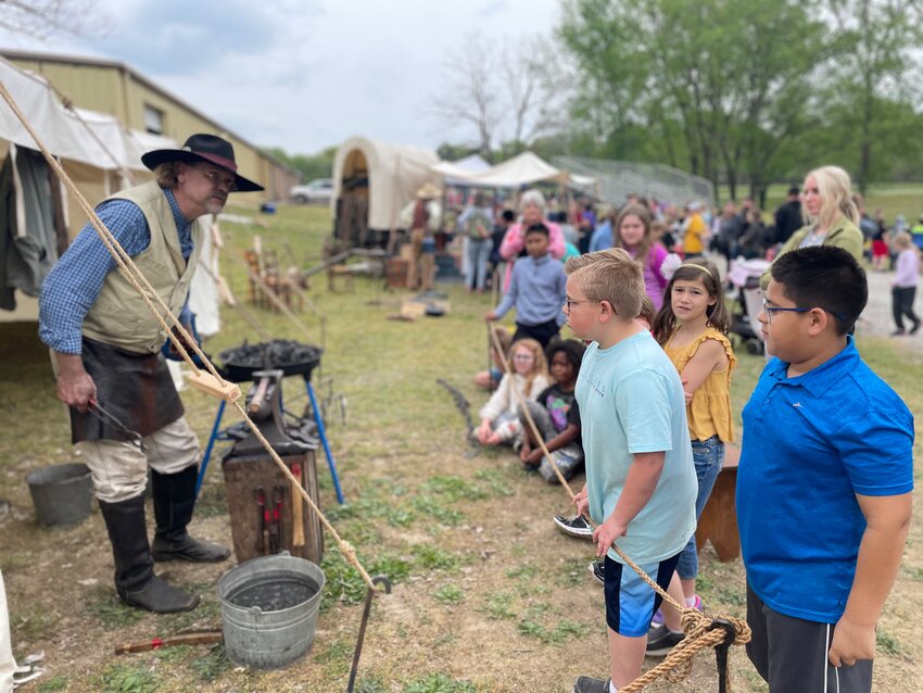 Students get a close up look at what it takes to be a blacksmith at the Crawford County Historical Museum in Pittsburg. The museum often hosts events to take students and other visitors back in time for a glimpse of the past.&nbsp;