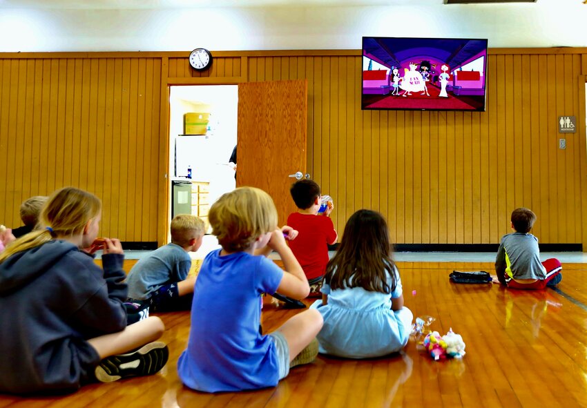Area children take a break from activities at Monday&rsquo;s final Camp Now and Then event and enjoy their lunches while watching an episode of &ldquo;Phineas and Ferb.&rdquo;