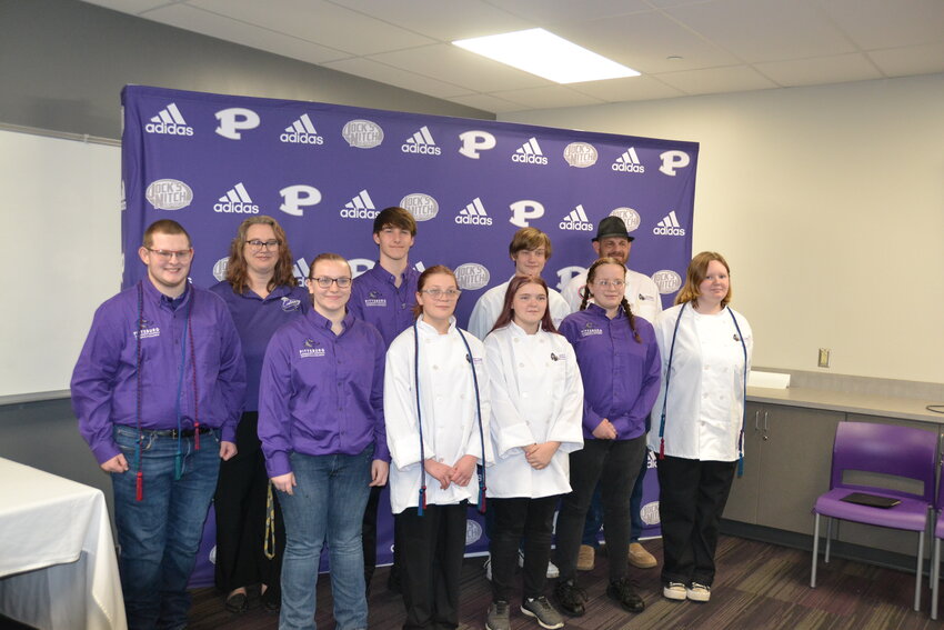 Members of the PHS Culinary Arts team. Made up of two teams, Culinary (in white) and Management (in purple), the students participated in a state-wide contest involving all facets of the restaurant and hospitality industry &ndash; from cooking a multi-course meal to developing a business plan. In their first competition, the Management team took 6th and the Culinary placed 7th, although their pork dish placed 2nd.