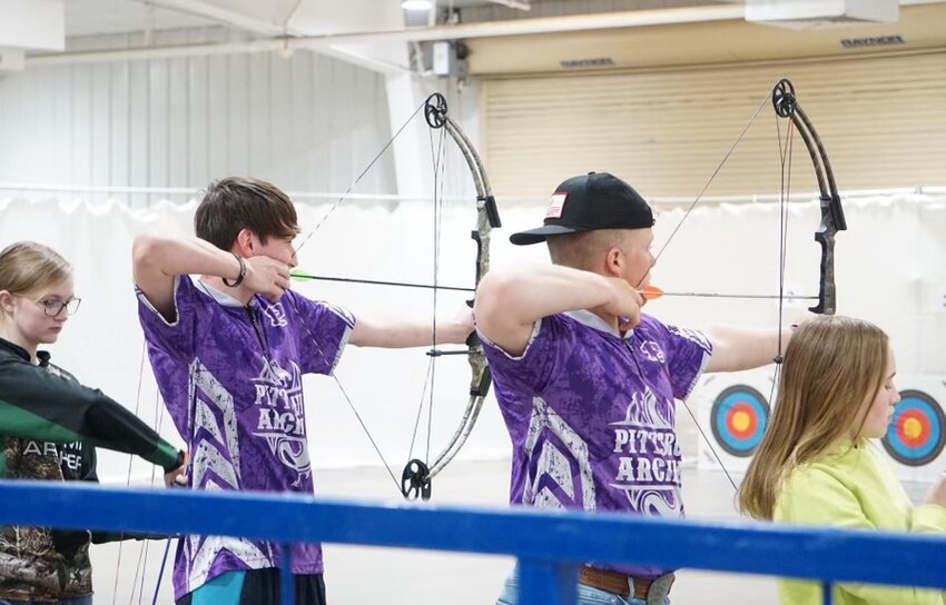 PHS archers Andrew Deierling (right) and Tucker Akins (left) compete during the Kansas State archery tournament in Hutchinson.