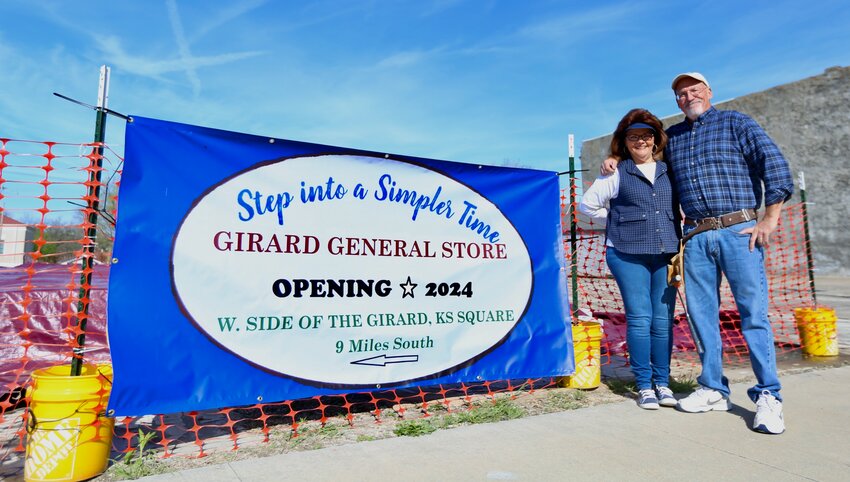 Jim and Kathi Cooper stand next to their signage that will soon be placed outside Crawford State Park in Farlington as the two continually work on completing the &ldquo;Girard General Store,&rdquo; which has an anticipated completion date of August 2024.