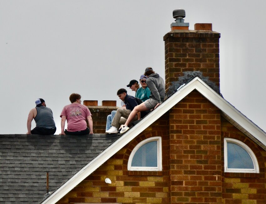 Fraternity members at Sigma Tau Gamma on the campus of Pittsburg State University climb to get a higher view on the rooftop compared to those positioned down at the Carnie Smith Stadium football field during Monday&rsquo;s eclipse as people across the world witnessed the special occasion.