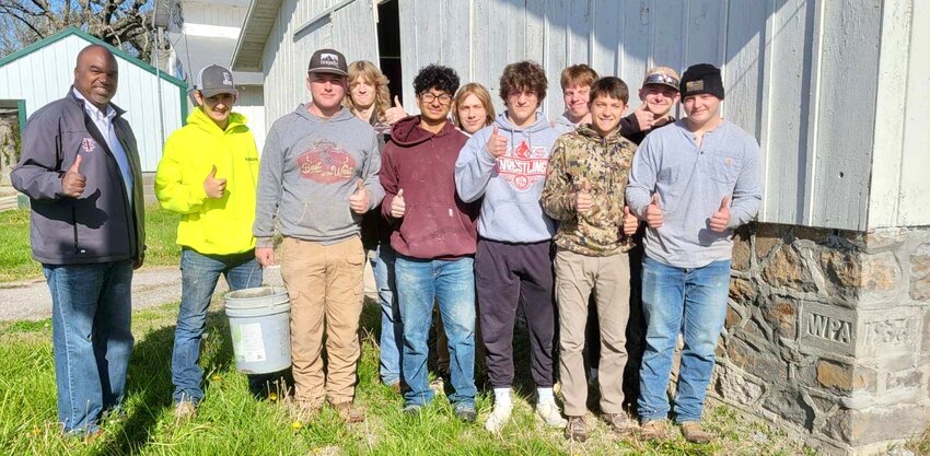 Students at the Career and Technical Education Center of Crawford County take a break from their masonry work at the Crawford County Fairgrounds on Tuesday to pose for a photo with Fort Scott Community College President Jason Kegler. The students are helping restore historic structures at the fairgrounds.