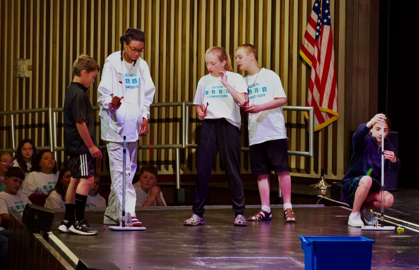 Sixth graders from county schools work together to place a rocket into a box, using teamwork and leadership skills at Tuesday&rsquo;s Youth Leadership Program graduation held at Memorial Auditorium.