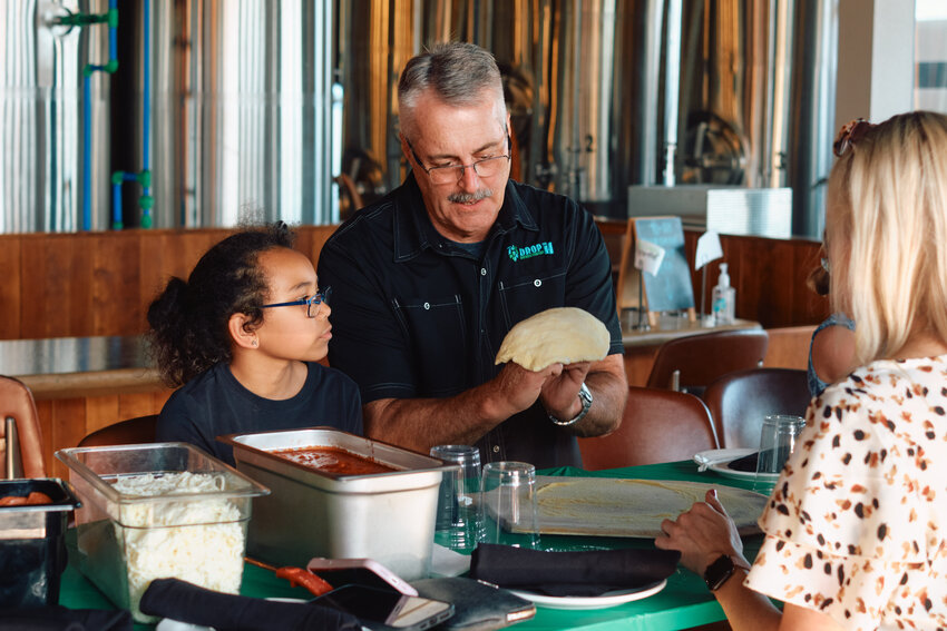 &quot;Mark McClain, owner of Drop the H Brewing Company, teaches the art of craft pizza during a special event with Big Brothers Big Sisters of Southeast Kansas. More than 20 matches attended the event, which was sponsored in part by the Community Foundation of Southeast Kansas.&quot;