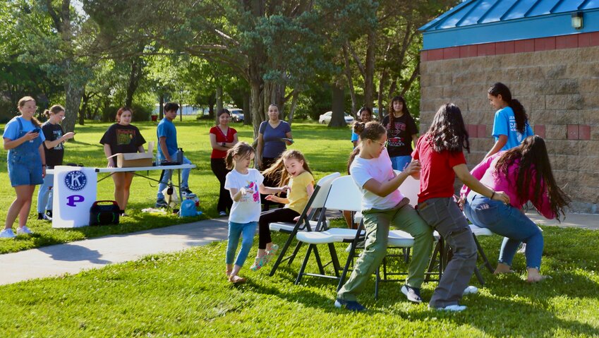 A group of children play musical chairs at &ldquo;Hispanic Family Night,&rdquo; Friday, in Schlanger Park. The event, which included free food and games, was hosted by SparkWheel.