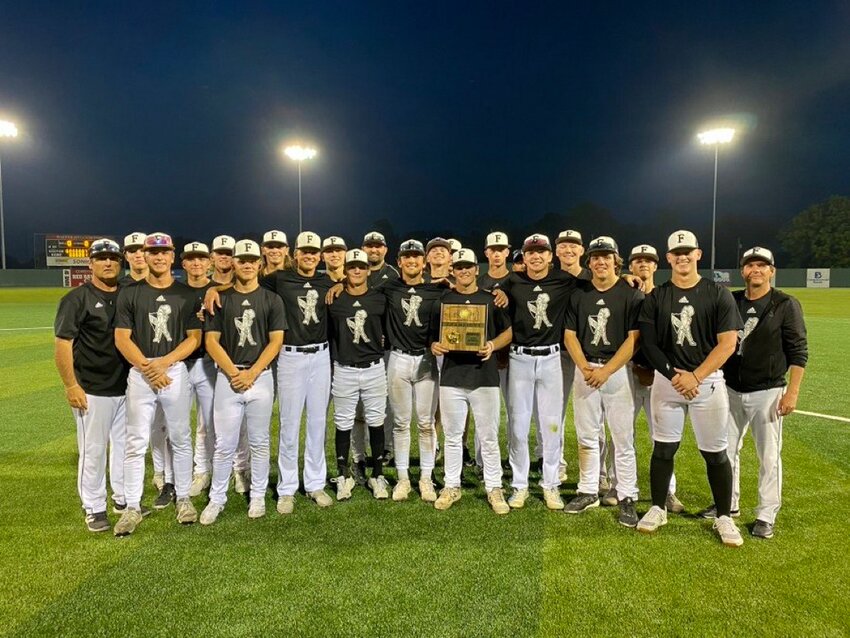 The Frontenac Raiders pose with the regional championship trophy after beating Riverton on Tuesday in Coffeyville.