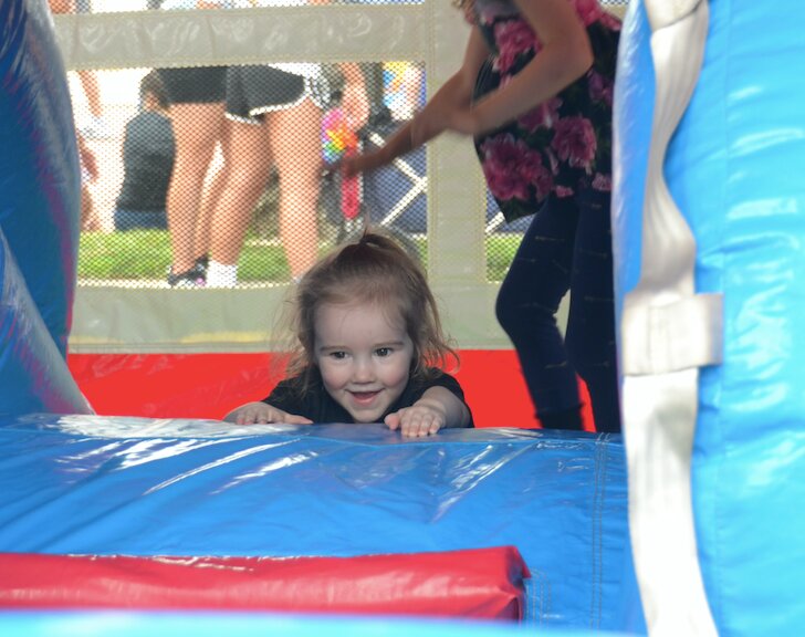 Miss Everlie enjoys her time in the bouncy house with a mischievous grin during Fort Scott&rsquo;s annual Good Ole Days celebrations.