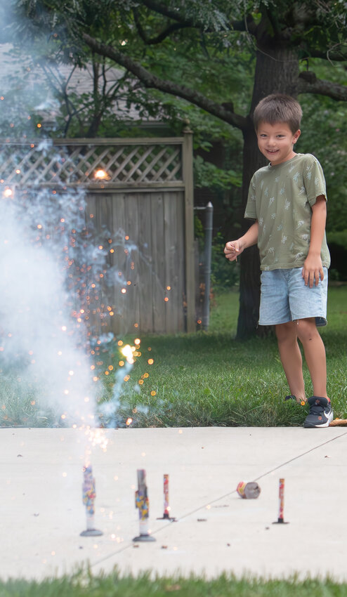 Six-year-old Nicholas Hsieh finishes off the last of his fireworks stash in Pittsburg on Thursday evening. A late evening storm forced the City of Pittsburg to postpone its fireworks display until Friday night, which was also the last night that city ordinances allowed fireworks to be discharged by citizens until next July.