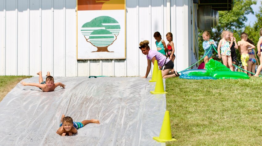 A group of kids glide along the slip and slide to the east of the Greenbush Astrophysical Observatory during Thursday&rsquo;s &ldquo;Splish Splash&rdquo; summer camp, held for kids first through eighth grade.