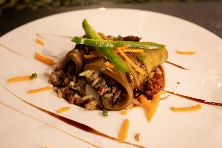 Pictured is a grilled eggplant roll with fresh olive and cucumber salad made by Chef Cesar Paul.