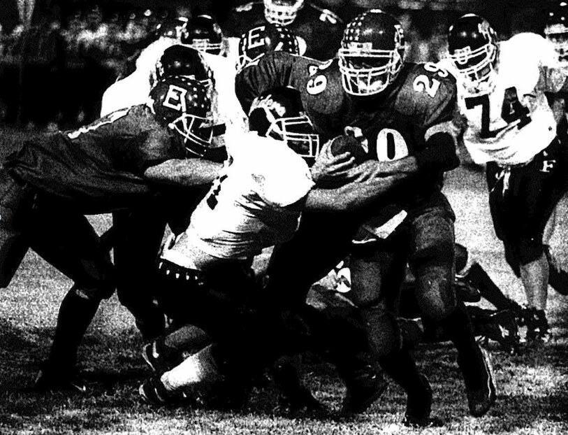 Erie running back Derek Sears tries to break through the line in the Red Devils&rsquo; 15-7 victory over the Frontenac Raiders, putting Erie in the Class 3A playoffs for the fifth straight season.