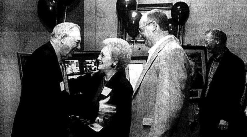 Dr. R.V. Haderlein, left, is congratulated by Edwina and Jerry Stanton during dedication ceremonies for the Robert V. Haderlein Building at SEK Education Services in Greenbush.