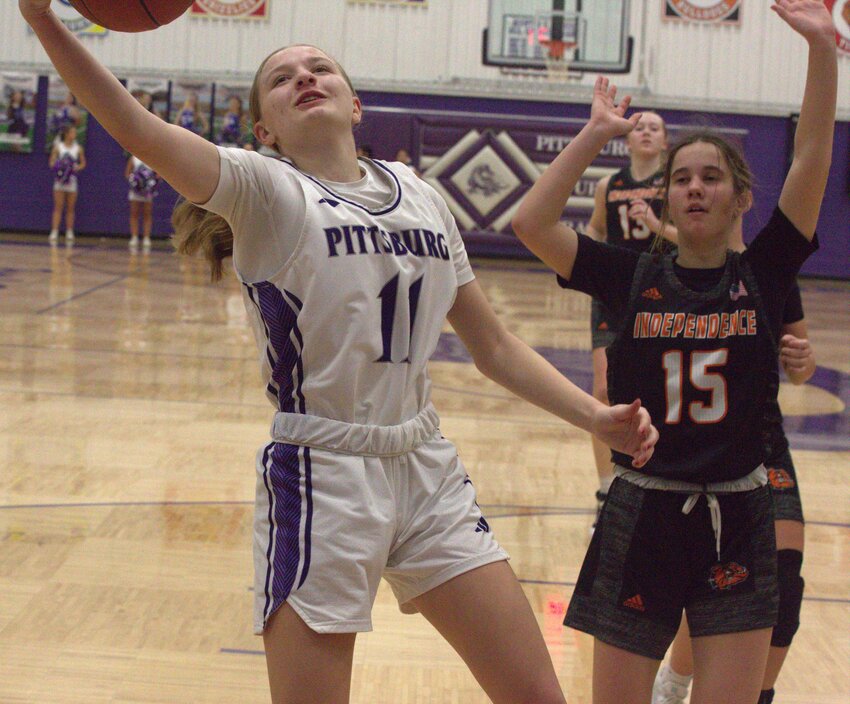 Pittsburg junior Sophia Hertrich drives to the basket and draws a foul in the first half Tuesday night against Independence. Hertrich made 7-of-7 free throws on her way to 17 points. BROCK SISNEY / THE MORNING SUN