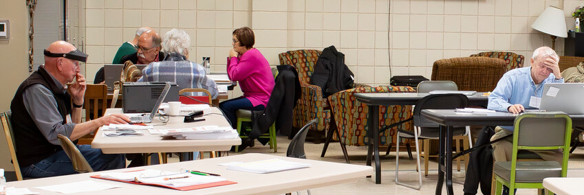 Consultants assist taxpayers at the Homer Cole Community Center Friday as a free southeast Kansas AARP TaxAide program. The program will help clients every week until April.
