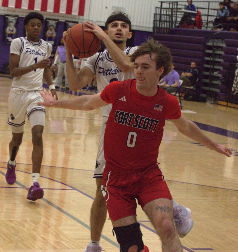 Pittsburg junior Kadin Navaratnam avoids Fort Scott&rsquo;s Dub Chipman during their game Friday night. BROCK SISNEY / THE MORNING SUN