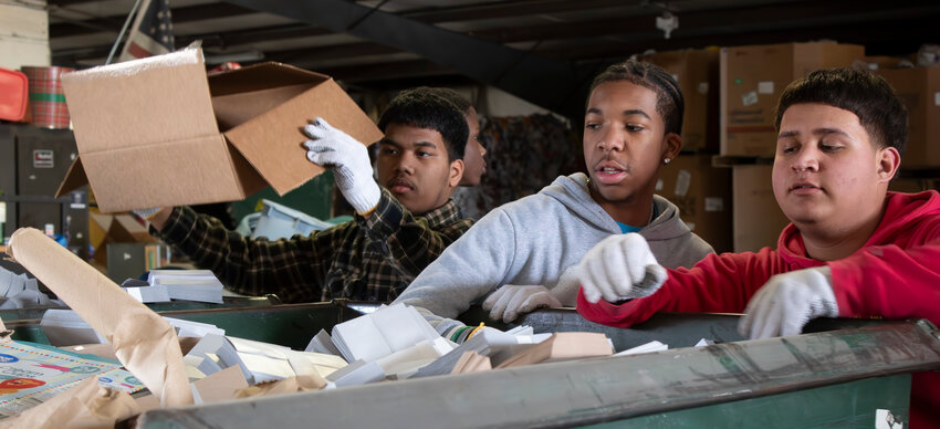 From left, Pittsburg High School juniors Rickton Johnny, Keyon&rsquo;Dre Logan and David Dominguez sort through a bin of paper March 6 at the Southeast Kansas Recycling facility, located at 615 S. Joplin Street in Pittsburg. More than 20 students volunteered at the facility as part of their Jobs for America&rsquo;s Graduates (JAG) program.
