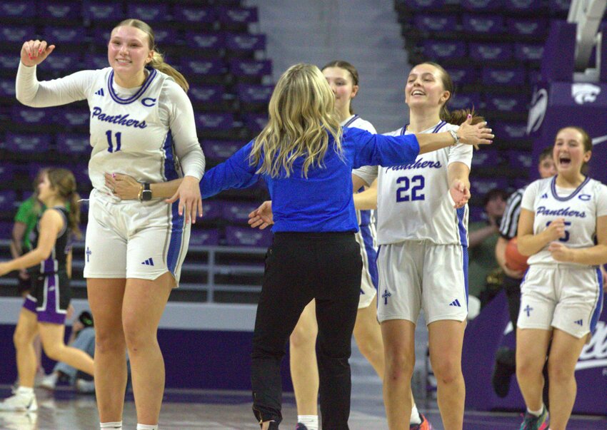 St. Mary's Colgan head coach Abby Farabi celebrates with seniors Mariah Harris (11) and Molly Swezey (22) moments after Colgan's 41-37 quarterfinal win Thursday night against Valley Heights at Bramlage Coliseum.