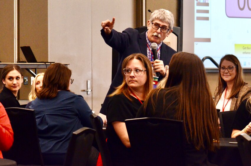 Dr. Mark Johnson, a university professor at Pittsburg State University, helps attendees navigate the ballrooms within the Overman Student Center during Friday&rsquo;s HRD Four-State Conference.