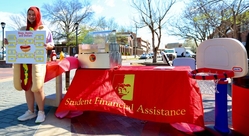 Staff members at Pittsburg State University&rsquo;s Office of Student Financial Assistance passed out free hot dogs and offered students the chance to flex their basketball skills while making sure financial assistance is in order. With senior student Macy Cussimanio dressed up in a hot dog costume, financial aid specialists answered students&rsquo; questions about their FAFSA, institutional scholarships, private loans, and Pell grants.