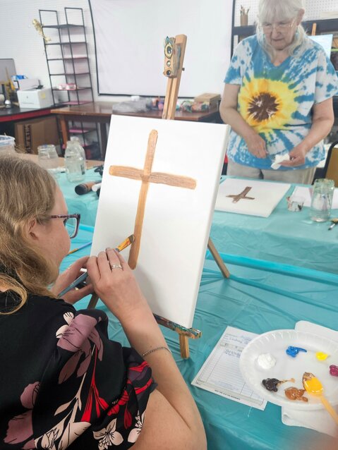 Acrylic painting art student Lindsey Grieve listens attentively to instructions by Glick.
