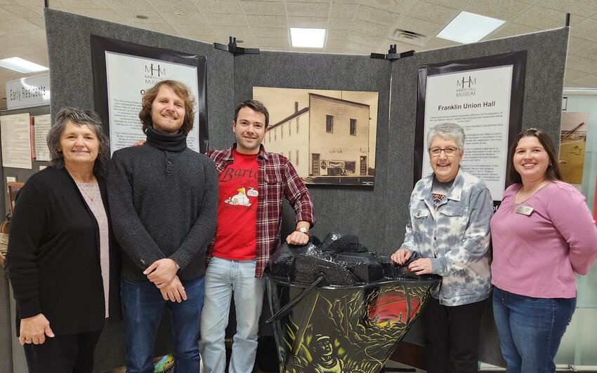 Phyllis Bitner, left, and Christie Parrish and Susan Bestor, right and far right, played host to visiting photographers Valerio Geraci and Sinbad during a vist to Miners Hall Museum where they were allowed access to artifacts, photos, and historical documents about Italian immigrants to Southeast Kansas.