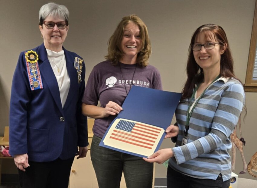 Greenbush teachers Katrina Bennett and Jennifer Luna received braille flags from Mary Gilpin, Regent of the Oceanus Hopkins Chapter of the Daughters of the American Revolution.