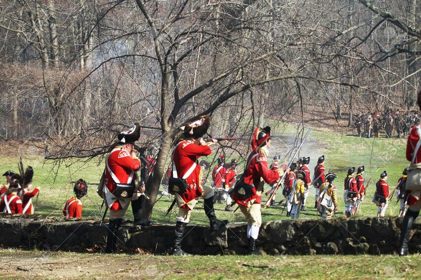 Grenadiers, in the foreground wearing bearskin caps, provide covering fire as a Light Company prepares to drive off colonial militia drawn up in the trees.