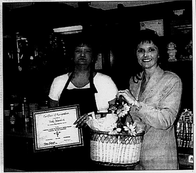 Karen VanLeeuwen, right, chairman of the Crawford County Convention &amp; Visitors Bureau Advisory Board, presents the April ASK Award for outstanding customer service to Vicki Murdock of Harry&rsquo;s Caf&eacute;.