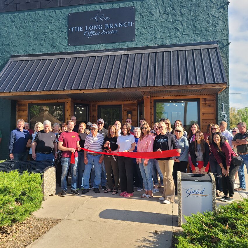 Girard Chamber of Commerce members and The Long Branch Office Suites Owners Troy and Lisa Blair and their daughter, Brooke Mahnken cut the ribbon on their new business. The space has eight rentable office suites and one conference room.