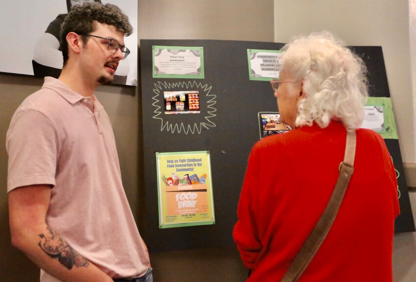 PSU student Chance Rea talks with a community member during Monday&rsquo;s PSU Social Work Program Community Project Showcase, held on the second floor of Russ Hall, as students discussed their project that tackled social problems or unmet needs.
