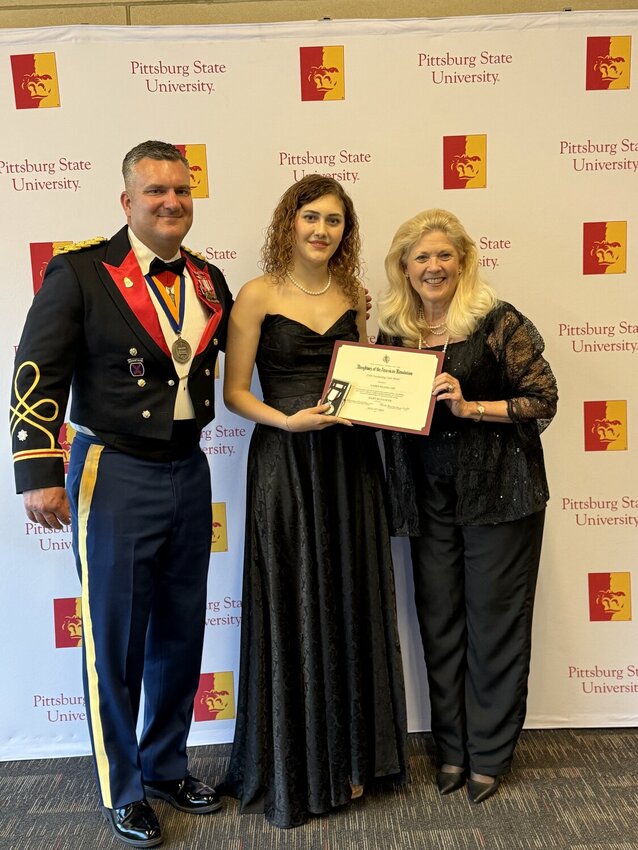 The ROTC awards banquet traditionally kicks off the commencement season at Pittsburg State.&nbsp; Cadet Elaina Lee, center, poses with LtCol Dustin Bloom, Pittsburg State ROTC commanding officer, and Mary Jo Dance, right, of the Pittsburg Oceanus Hopkins chapter of the Daughters of the American Revolution. Lee was presented the DAR Outstanding Cadet Medal for her leadership and dedication at Friday night&rsquo;s ceremonies.