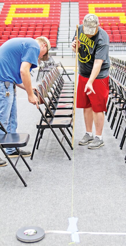 Little things matter. A crew of Pittsburg State University employees worked Wednesday to prepare John Lance Arena for Spring Commencement exercises on Friday and Saturday. Wyatt Hull, left, and Tony Jameson made sure the chairs for the graduates were evenly spaced as coworkers set the stage and cleaned the seating area for guests. Commencement ceremonies are scheduled for 3 p.m., 5 p.m. and 7 p.m. on Friday and for 9 a.m., 11 a.m. and 1 p.m. on Saturday.