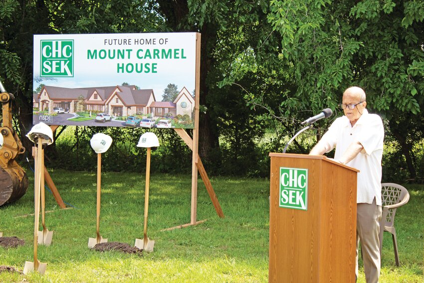 Community Health Center of Southeast Kansas Founding Board Member Dr. Daniel Minnis tells the story of his near-death experiences Thursday during the groundbreaking of the Mount Carmel House, a hospice center. The facility is scheduled to be completed in 2026.