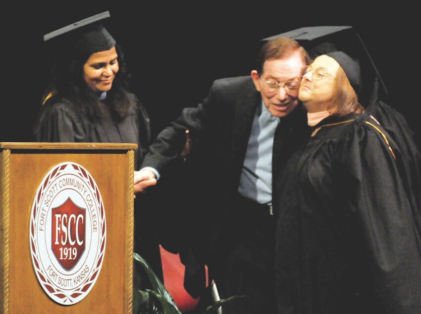 Arma native Marcel Normand, center, was recognized during Friday&rsquo;s commencement ceremonies at Fort Scott Community College. For more than 25 years, Normand worked as a history teacher at the college, inspiring students with his unique style of teaching history by focusing on the story. An Honorary Degree was presented to Normand by Ronda Bailey, right, a member of the FSCC Board of Trustees and a former student.