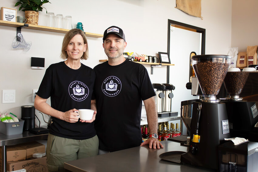 Owners Brad and Andra Stefanoni stand behind the counter June 4 at McKay Street Coffeehouse, 200 E. McKay Street in Frontenac. The business is full of nostalgia for the couple as two of Brad&rsquo;s childhood tow trucks are displayed on the wall along with historic black and white photos of the family.