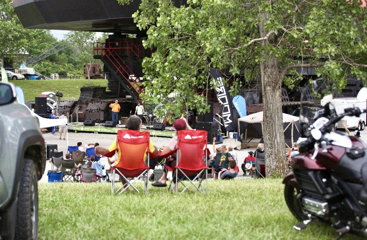A couple sits and watches the events unfold at the Big Iron Overland Rally near West Mineral on Saturday.