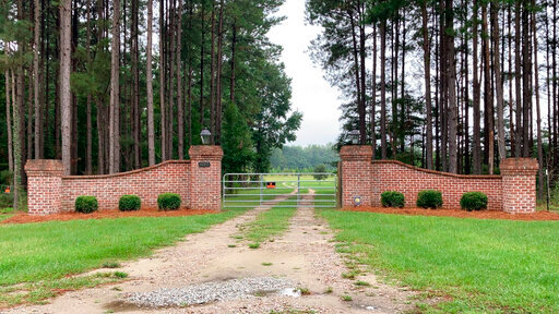 FILE - The gates near Alex Murdaugh's home in Islandton, S.C., are seen on Sept. 20, 2021. The shooting deaths of South Carolina lawyer Alex Murdaugh's wife and son started a chain of investigations, strange happenings and legal maneuvers over the past 13 months that his lawyer said in July 2022, will lead to murder charges soon. (AP Photo/Jeffrey Collins, File)